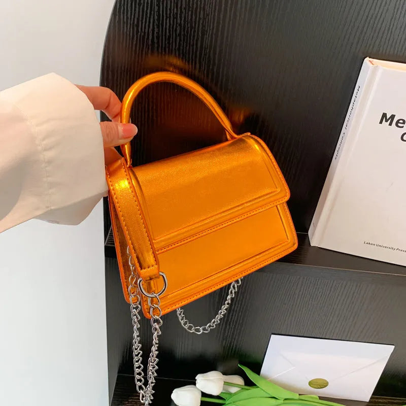 Retro style square PU leather crossbody bag in multiple colours on a model.