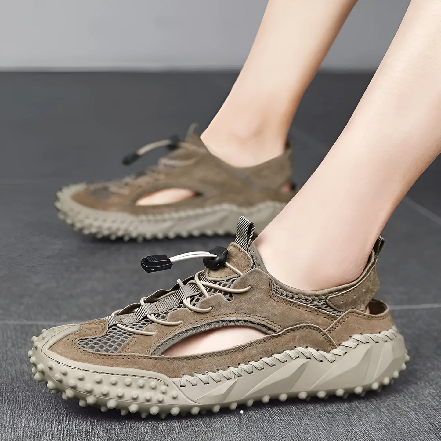 Men's black waterproof sports sandals with leather mesh upper, elastic band, and rubber sole.
