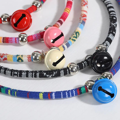 Adjustable coloured ethnic-style pet collar with a small bell, shown in multiple colour options.