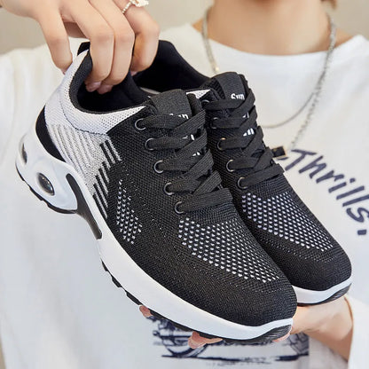Women's striped Flyknit casual running shoes in pink, shown with a flat PVC sole and front lace-up closure.