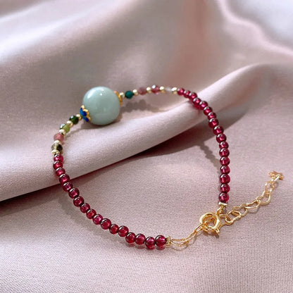 Aquamarine coloured drop shape tourmaline bracelet with garnet electroplated finish