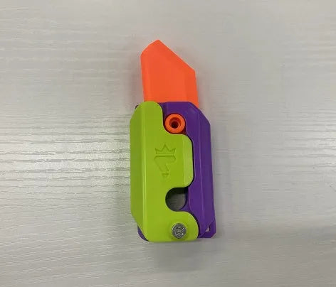 Small orange and green 3D printed plastic carrot knife fidget toy with blade extended.