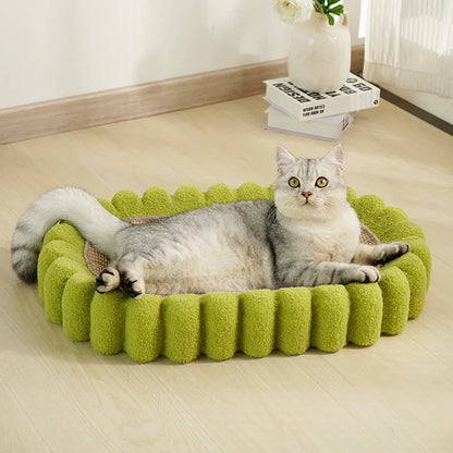 Green oval-shaped sisal cat scratching pad with a central bowl, serving as a cat bed and furniture protector.