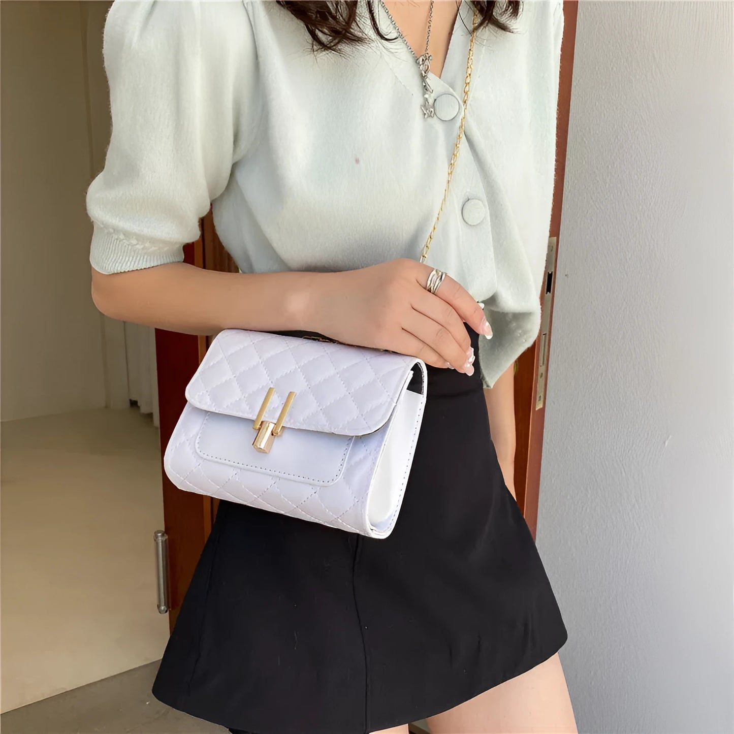 Women's solid colour PU leather crossbody bag with diamond lattice chain strap in black, green, or white.