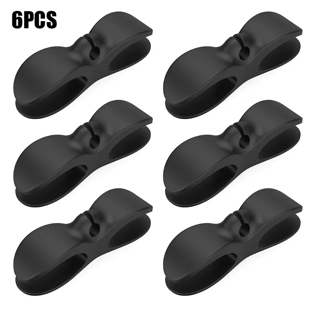 Black TPU cable organizer clips winding appliance cords on kitchen counter, 5cm size, non-marking adhesive for tidy management