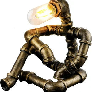 Vintage industrial iron pipe table lamp with soft, warm lighting and a green bronze finish