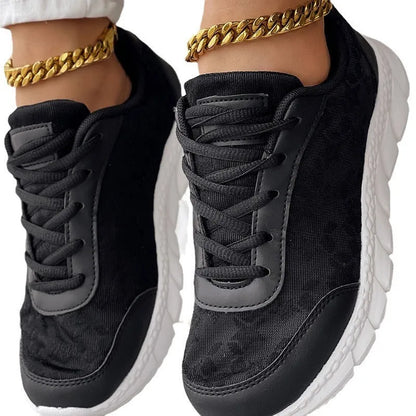 Women's canvas sports shoes in white with round toe and flat heel design on a light background