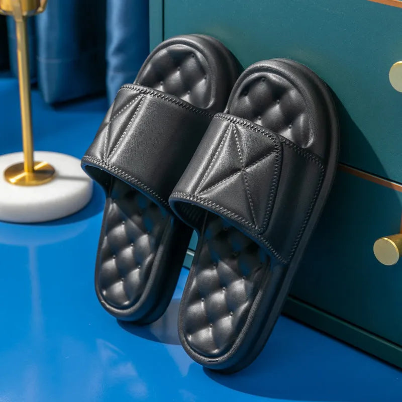 A pair of thick-soled EVA bathroom slippers in a selected colour, showing their injection-moulded non-slip design.