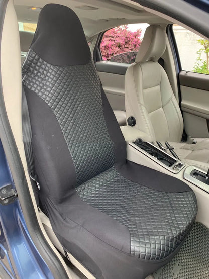 Black quilted universal car seat cover fitted on a front car seat, showing diamond stitching and plastic hook fastenings.