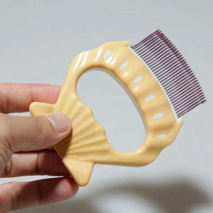 Shell-shaped plastic pet grooming brush with bent wire bristles in green, orange, or purple colours