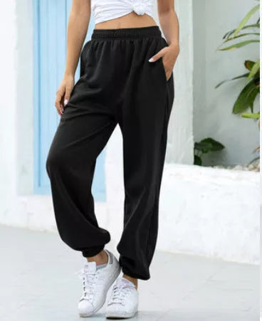 Plus-size slacks in black, grey, and green with elastic waistband