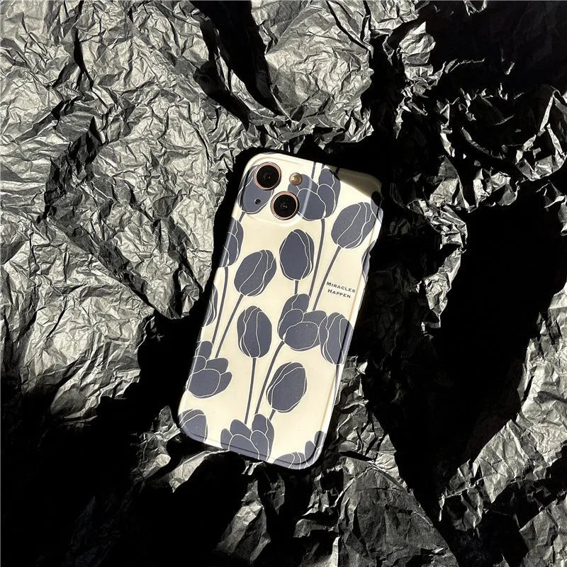 Cold Wind black silicone iPhone case with a white tulip floral pattern on the back.