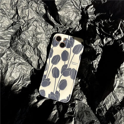 Cold Wind black silicone iPhone case with a white tulip floral pattern on the back.