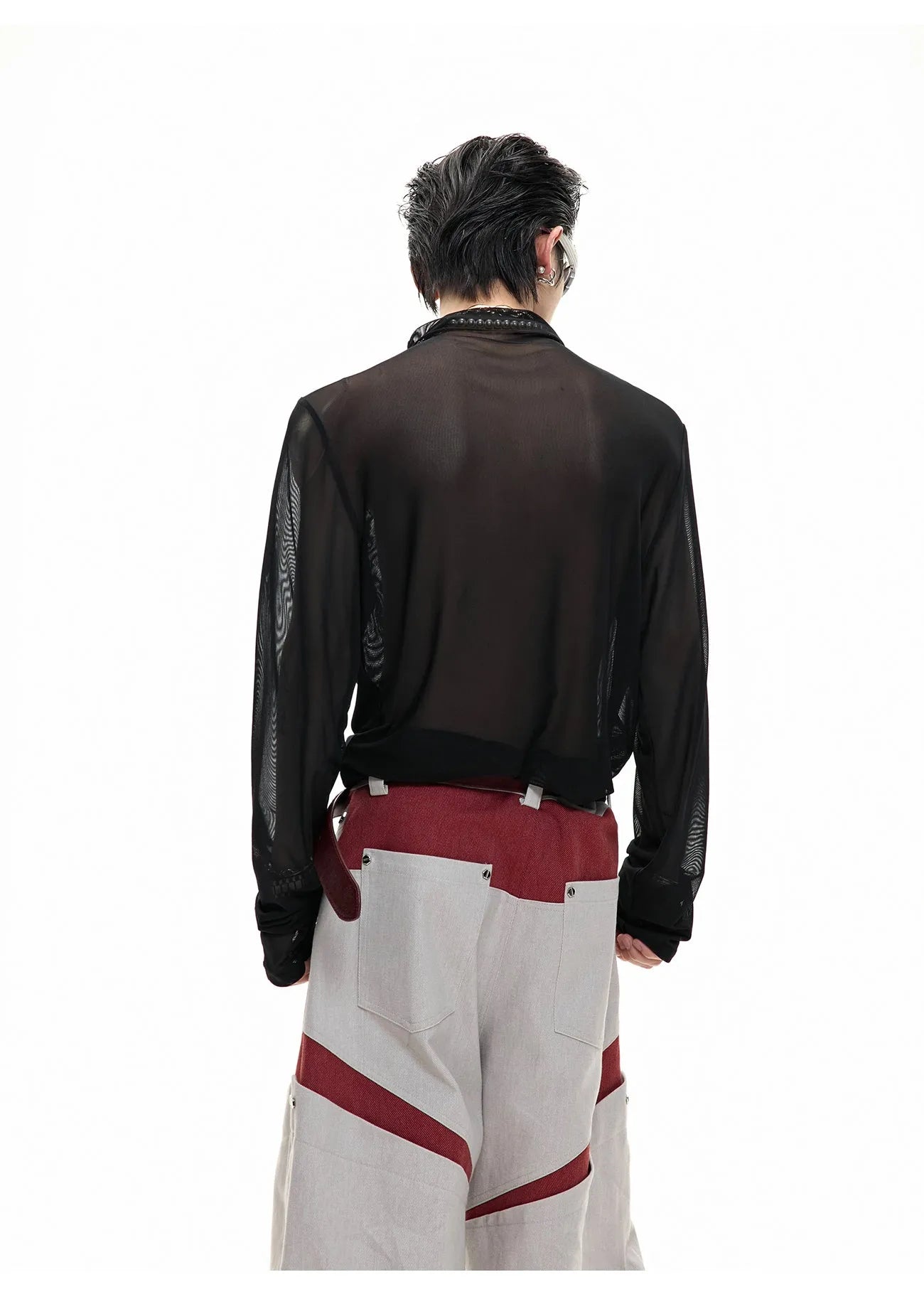Man wearing a black slim-fit niche mesh long sleeve base layer shirt.