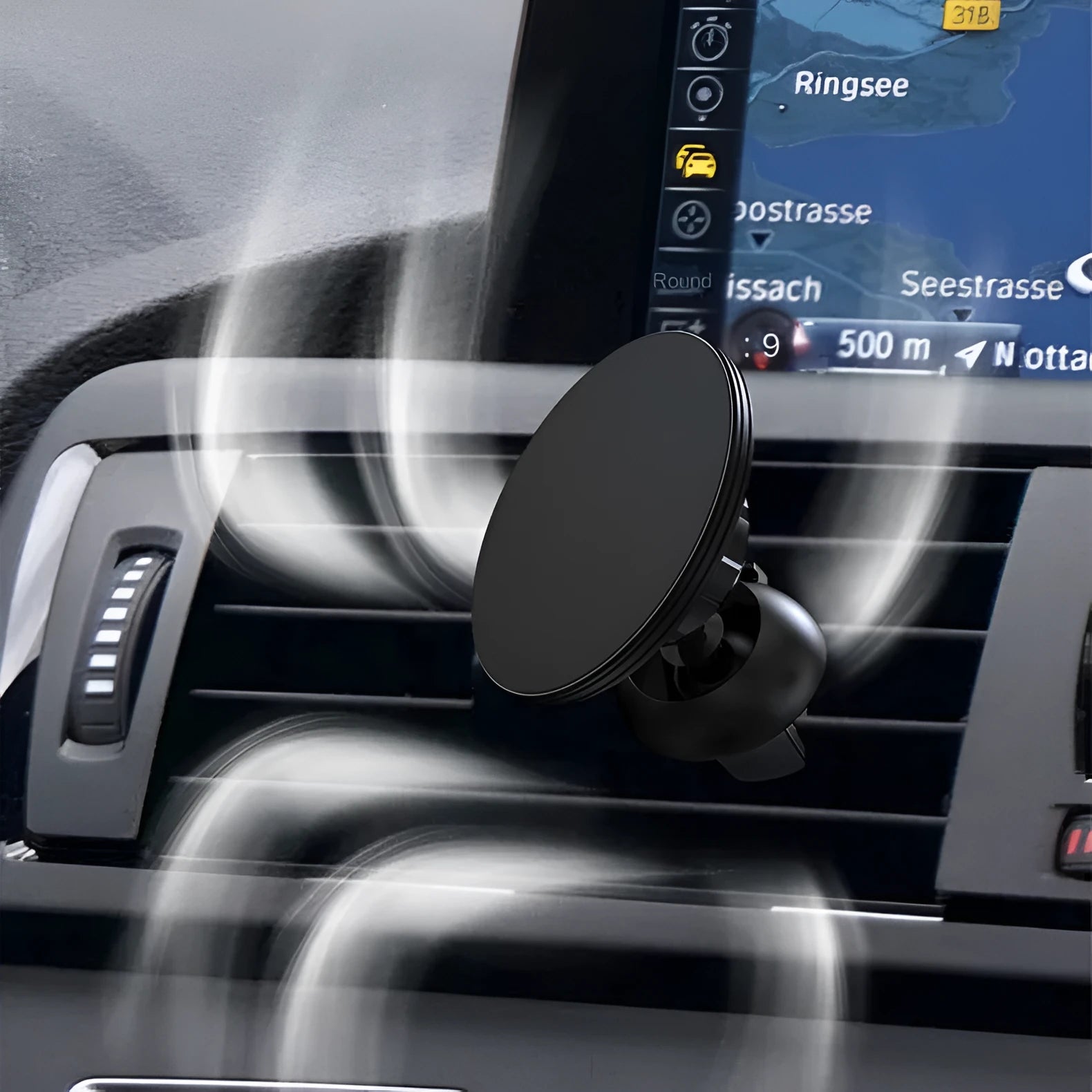 Black aluminium alloy magnetic phone holder clipped onto a car air vent, holding a smartphone securely.
