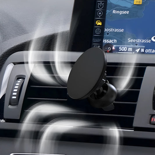 Black aluminium alloy magnetic phone holder clipped onto a car air vent, holding a smartphone securely.