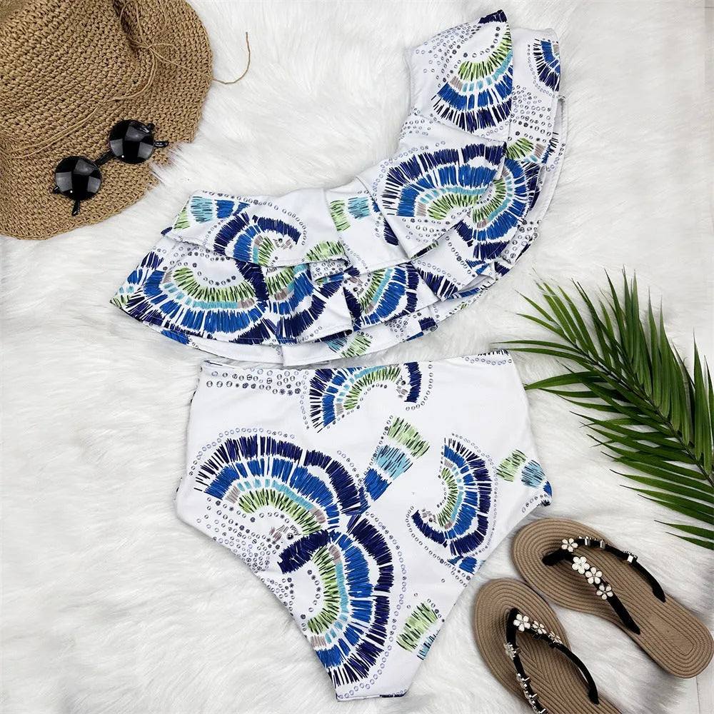 White women's one-shoulder swimsuit with large lotus leaf detail and split hem