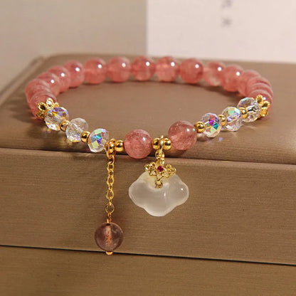 Women's adjustable crystal bracelet with strawberry quartz, white agate beads, and auspicious cloud charms