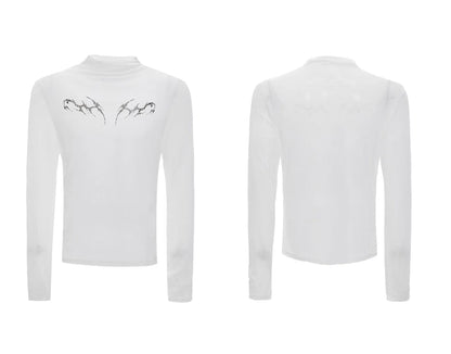 Man wearing a black slim-fit niche mesh long sleeve base layer shirt.
