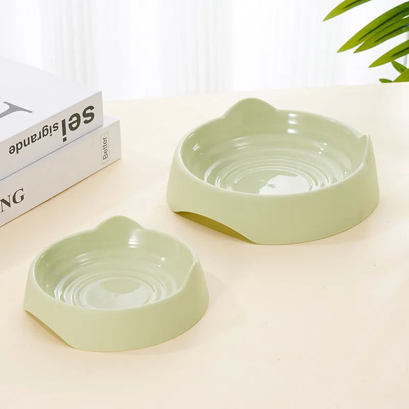 Blue ceramic dog slow feeder bowl with maze of cups for slowing fast eaters, shown on wooden floor.