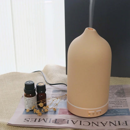 Ceramic ultrasonic aroma diffuser in white with 100ml tank, diffusing mist in home setting, 10cm diameter