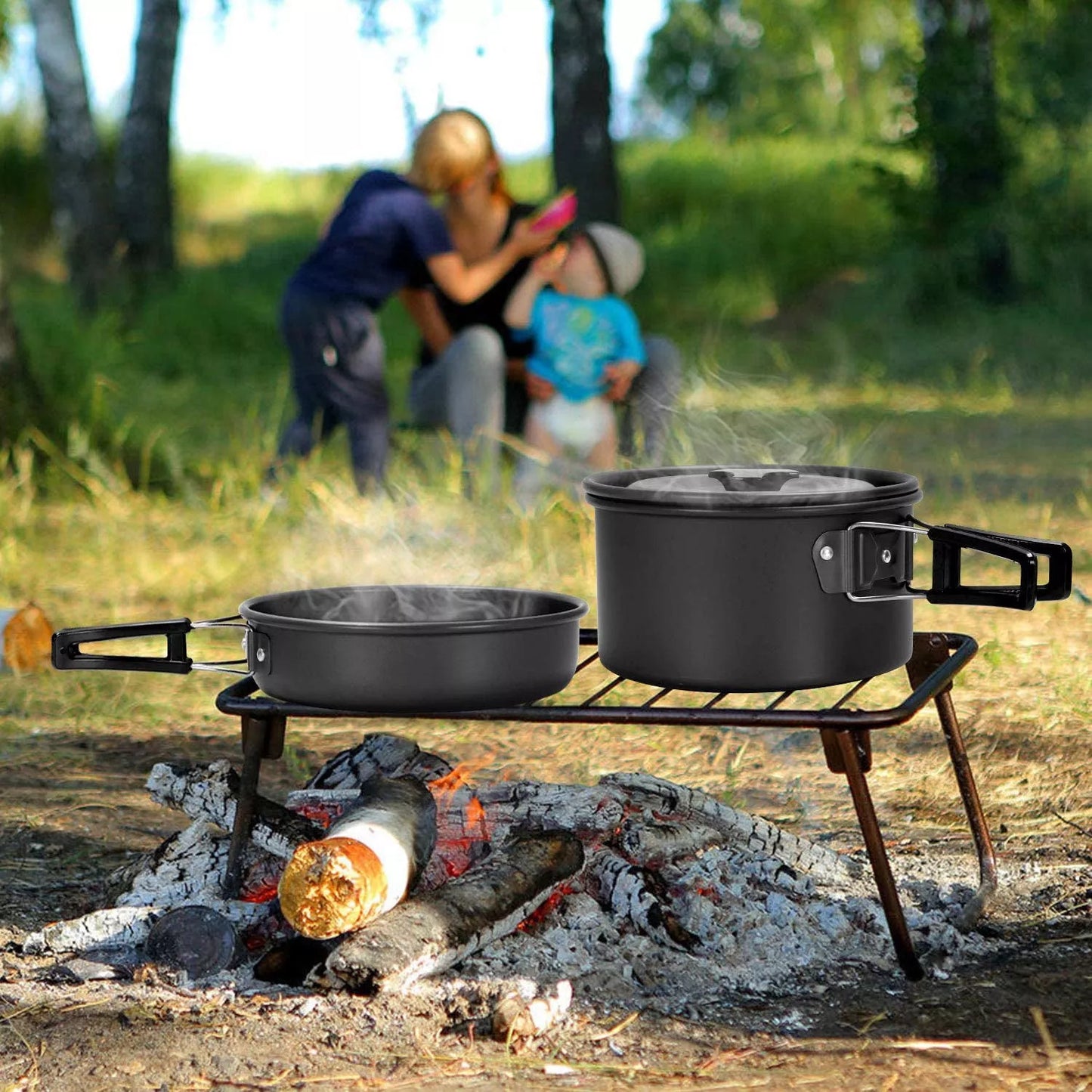 Camping cooker set with teapot, frying pan, and stainless steel utensils for outdoor dining