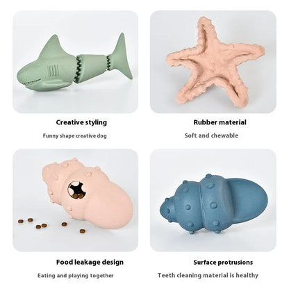 Blue rubber shark-shaped dog toy with food dispensing openings on a white background.