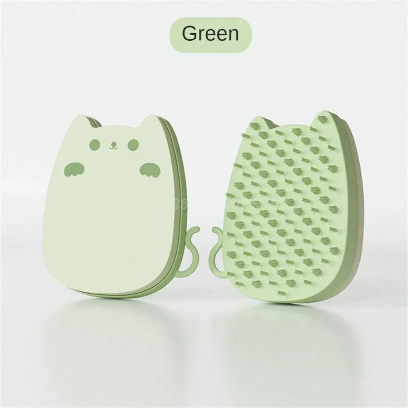 Blue silicone and sponge pet grooming brush with dual comb teeth on a wooden surface.