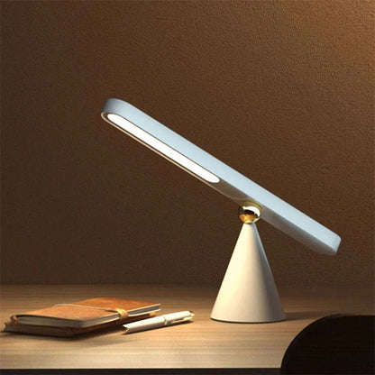A modern, geometric desk lamp with wireless charging and a magnetic suction base for easy placement