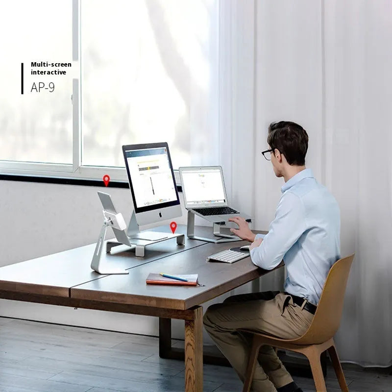 Black aluminium alloy laptop stand raising a laptop for ergonomic desktop use
