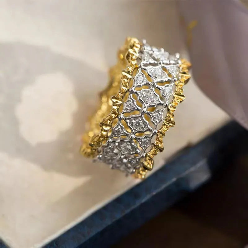 Geometric two-tone zircon ring with electroplated gold finish on copper, showing round elements and angular design