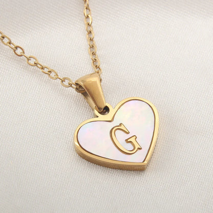 Gold-plated clavicle necklace with a white shell heart pendant, personalised with a letter from A to Z.