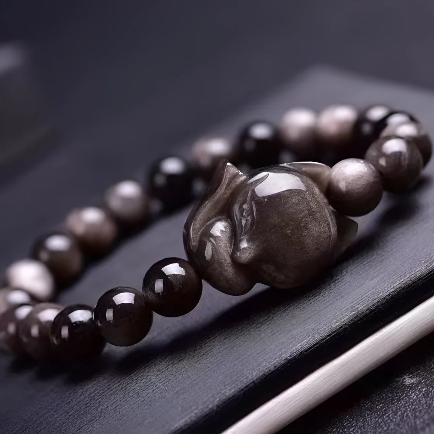 Obsidian fox bracelet with 8mm polished black stone bead and sterling silver fox charm on a bracelet chain.