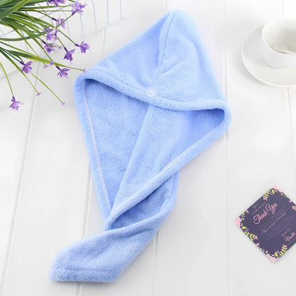Pink microfiber hair drying towel measuring 25x65cm with button fastening shown wrapped around hair