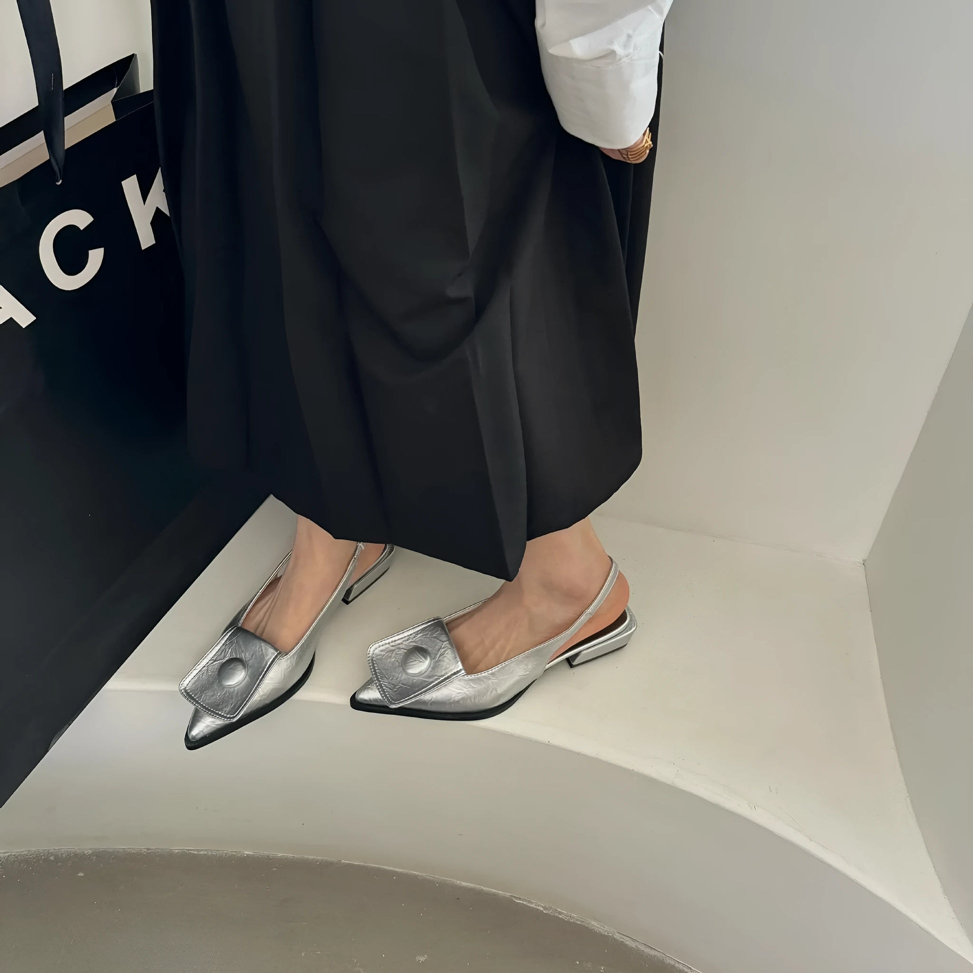 Women's low-heel pointed toe sandals with a back strap in black, brown, apricot, and silver colours.