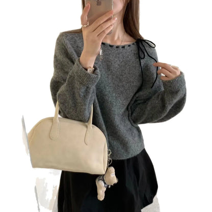 Women's loose-fitting grey pullover knitwear with relaxed silhouette, showing front view