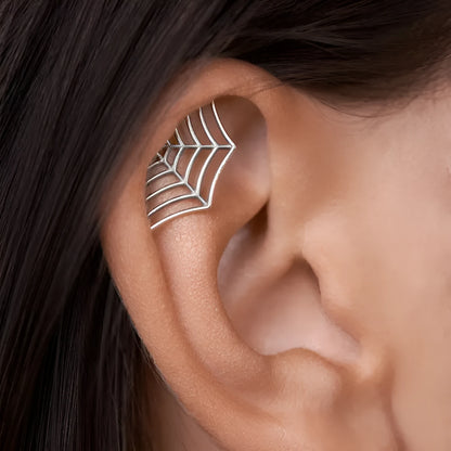 Spider web design stud earrings in gold and silver electroplated metal with geometric mesh pattern