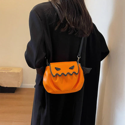 Halloween pumpkin cartoon crossbody bag with small wings in black, white, and orange