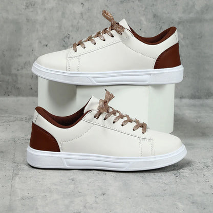 Beige brown women's low-top platform casual sneakers with a cross strap and round toe on a white background.