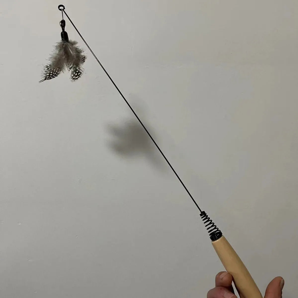 Wooden handle cat teasing stick with spring and replaceable feather bell head toy
