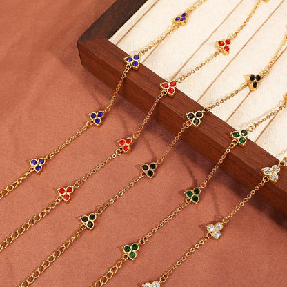Women's stainless steel bracelet with three triangle-shaped charms in different coloured stone settings