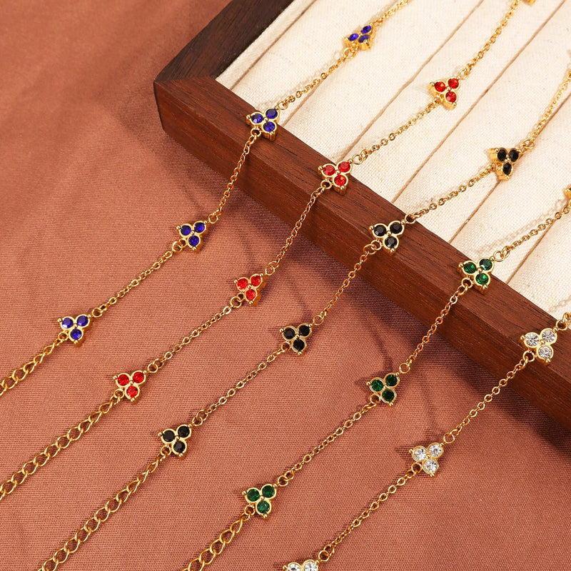 Stainless steel women's bracelet with three diamond-shaped triangle pendant charms in various coloured zircon or beka stone settings, a geometric jewellery piece available in gold-plated or steel tone finishes for everyday wear or light luxury styling