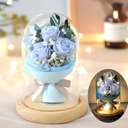Soap flower bouquet in glass display cover with red roses visible through clear 11.2cm dome