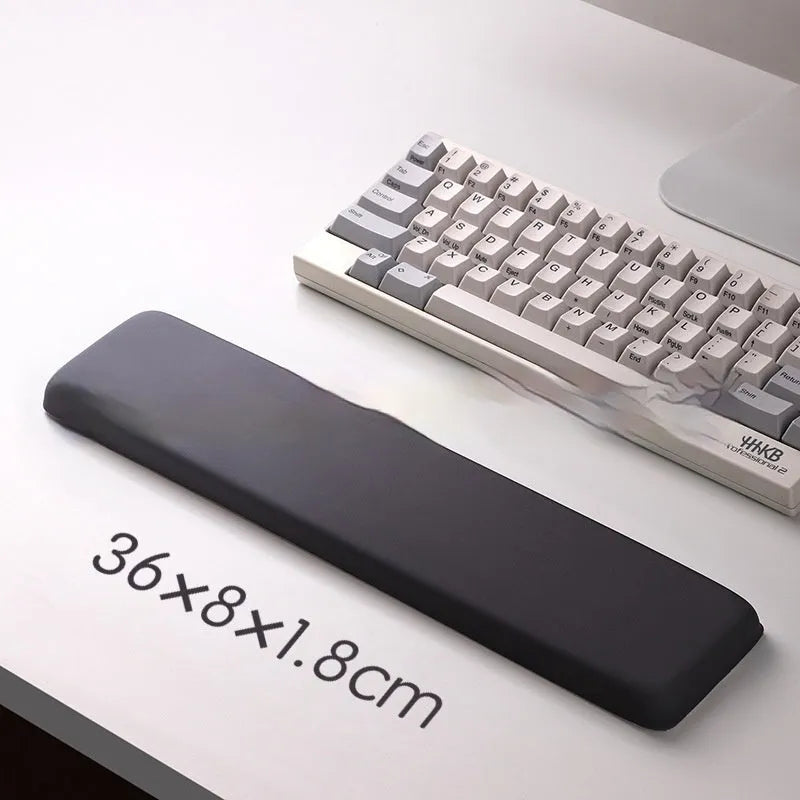 Square cloth mouse pad with grey silicone gel wrist rest and hand pillow on a wooden desk.