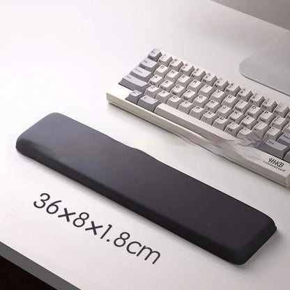 Square cloth mouse pad with grey silicone gel wrist rest and hand pillow on a wooden desk.