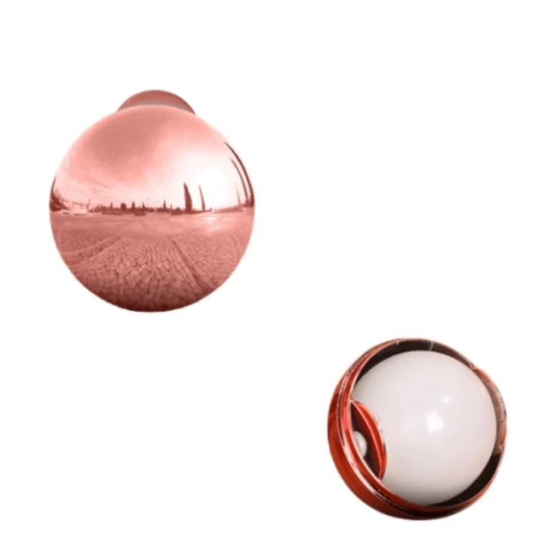 Premium reusable hair remover ball in liquid silver and rose gold colors, used to clean pet hair, lint, and dust from clothes and surfaces
