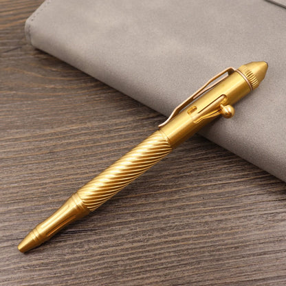 Brass tactical pen with press bolt mechanism showing cylindrical design and six ring details