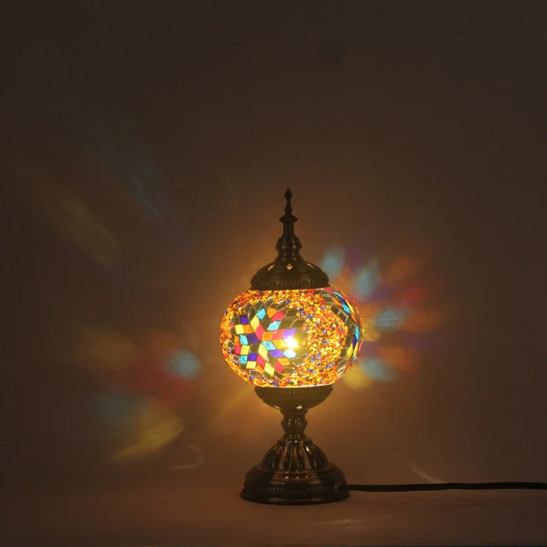 Glass table lamp with 150mm diameter shade and 330cm cord on wooden surface