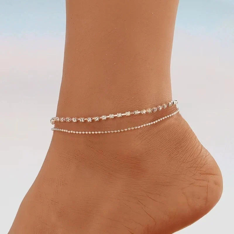 Women's geometric bead anklet with adjustable chain in gold and silver options.