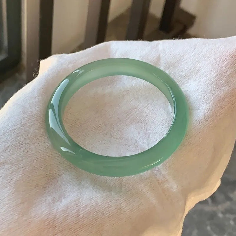 Natural agate wide tyre bracelet showing the stone's colour and the band's solid design on a wrist.